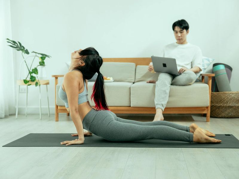 Bright and open space suitable for home workouts with a yoga mat on the floor.
